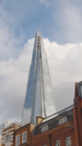 Vertical-Video-Of-Exterior-Of-The-Shard-In-London-UK-Against-Blue-Sky